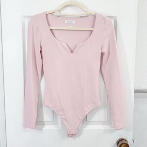 Pink Aritzia Babaton long sleeve bodysuit.